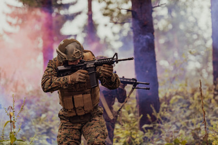 A group of modern warfare soldiers is fighting a war in dangerous remote forest areas. A group of soldiers is fighting on the enemy line with modern weapons. The concept of warfare and military conflictsの写真素材
