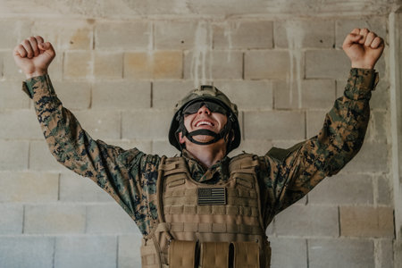 Success in the war campaign. A soldier with raised hands celebrates the successful conquest of enemy territoryの写真素材