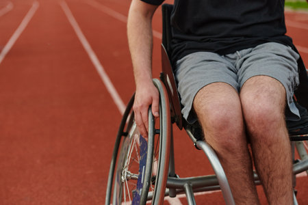 Close up photo of a person with disability in a wheelchair training tirelessly on the track in preparation for the Paralympic Gamesの写真素材