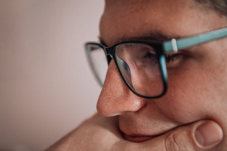 A programmer diligently testing smartphone applications while sitting in their office.の写真素材