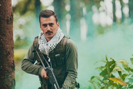 Angry terrorist militant guerrilla soldier warrior in forestの写真素材
