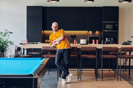 A man takes a brief rest from work in a modern startup coworking center, using the moment to...