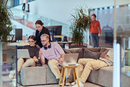 In a modern startup office, a diverse group of young professionals collaboratively tackles various...