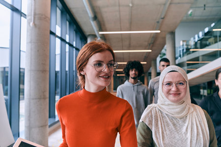 In the sleek corridors of a modern startup office, a diverse group of colleagues, led by their director, confidently stride forward, symbolizing collective success and the journey toward new business victories.の写真素材