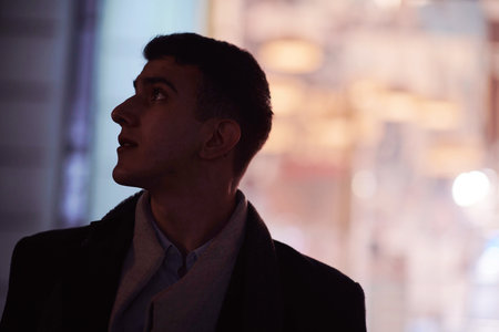 Smiling Meedle Eastern man walking down street near modern office building,の写真素材