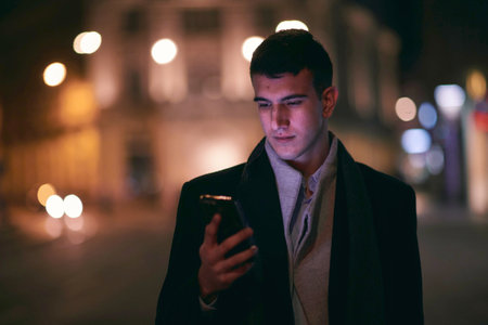 Smiling Meedle Eastern man walking down street near modern office building,の写真素材