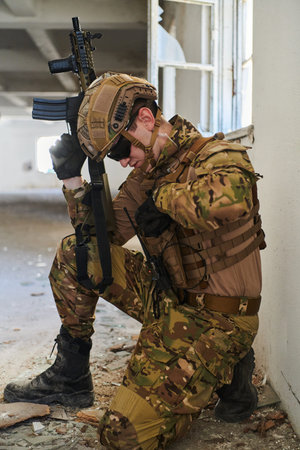 Soldier in action near window changing magazine and take cover