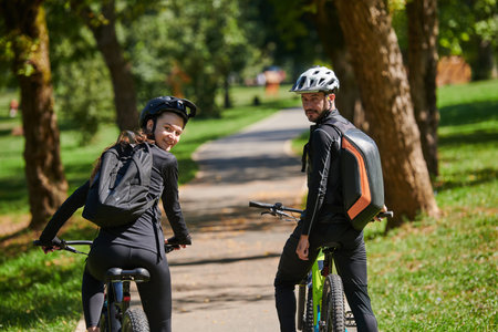 A blissful couple, adorned in professional cycling gear, enjoys a romantic bicycle ride through a...