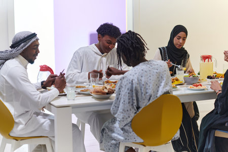 A traditional and diverse Muslim family comes together to share a delicious iftar meal during the sacred month of Ramadan, embodying the essence of familial joy, cultural richness, and spiritual unity in their shared celebrationの写真素材