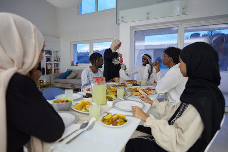 In the sacred month of Ramadan, a Muslim family joyously comes together around a table, eagerly...