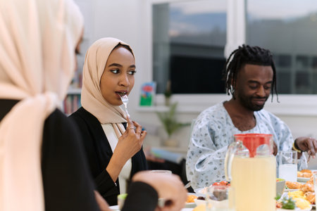A traditional and diverse Muslim family comes together to share a delicious iftar meal during the sacred month of Ramadan, embodying the essence of familial joy, cultural richness, and spiritual unity in their shared celebrationの写真素材