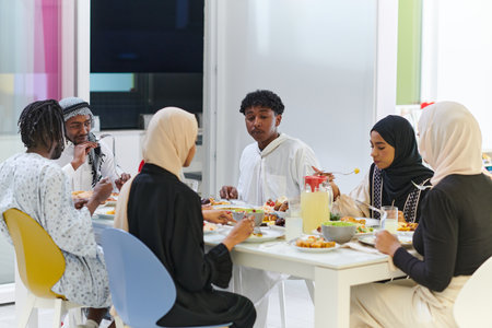 A traditional and diverse Muslim family comes together to share a delicious iftar meal during the sacred month of Ramadan, embodying the essence of familial joy, cultural richness, and spiritual unity in their shared celebrationの写真素材