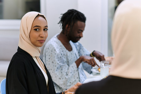 A traditional and diverse Muslim family comes together to share a delicious iftar meal during the sacred month of Ramadan, embodying the essence of familial joy, cultural richness, and spiritual unity in their shared celebrationの写真素材