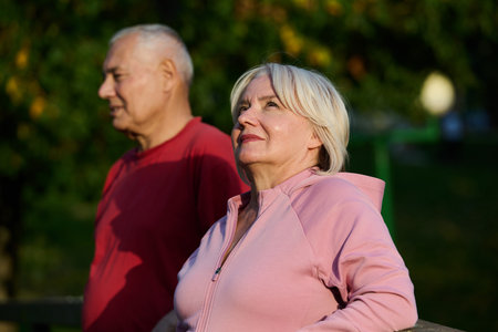 Elderly couple strolling through the breathtaking beauty of nature, maintaining their vitality and serenity, embracing the joys of a health-conscious and harmonious lifestyleの写真素材