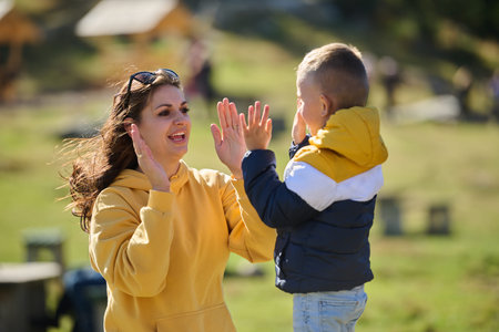 A mother and son create cherished memories as they playfully engage in outdoor activities, their...
