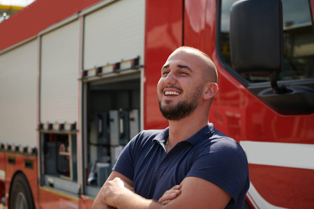 Confident firefighter stands with crossed arms, exuding resilience and preparedness, ready to...