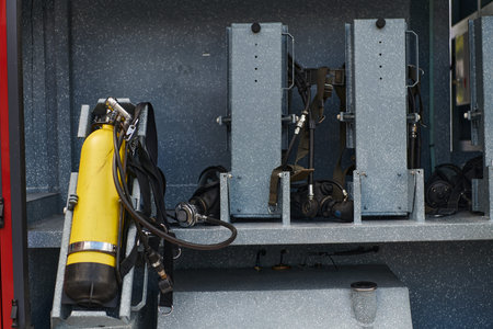 Close-up of essential firefighting equipment on a modern firetruck, showcasing tools and gear ready...