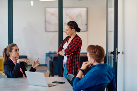 A team of successful programmers sits in a startup office, strategizing new business projects and solving existing challenges, showcasing innovation and collaboration in the tech industryの写真素材