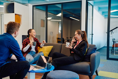 Multiethnic startup business team on meeting in a modern bright open space coworking office. Brainstorming, working on laptop. Group of coworkers walking around in motion blurの写真素材