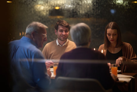 A modern and traditional European Islamic family comes together for iftar in a contemporary restaurant during the Ramadan fasting period, embodying cultural harmony and familial unity amidst a culinary celebration of diversityの写真素材