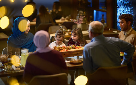 A modern and traditional European Islamic family comes together for iftar in a contemporary restaurant during the Ramadan fasting period, embodying cultural harmony and familial unity amidst a culinary celebration of diversityの写真素材