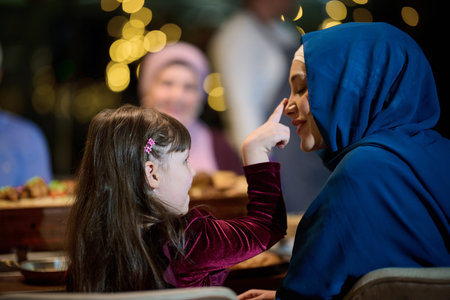 In a heartwarming scene, a happy European Islamic family and a young girl delightfully engage with...