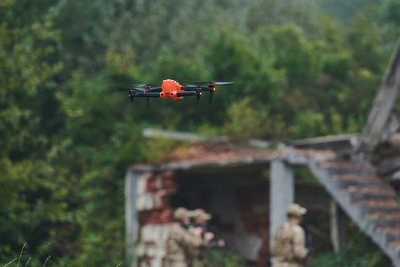 Elite military unit, equipped with state-of-the-art technology including a drone, strategically navigates and surveys dangerous wooded terrain, showcasing their precision, cooperation, and specialized training for high-risk operationsの写真素材