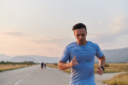 A group of friends maintains a healthy lifestyle by running outdoors on a sunny day, bonding over...