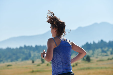 A determined woman athlete trains for success in the morning sun.