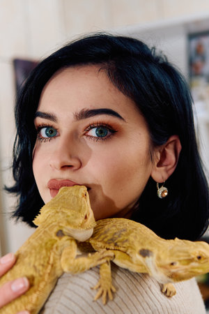 Beautiful Woman Posing with Her Two Adorable Bearded Dragon Petsの写真素材