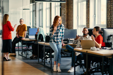 A diverse group of young business individuals congregates in a modern startup coworking center, embodying collaborative innovation and a dynamic atmosphereの写真素材