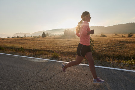 Determined Dawn: Confident and Motivated Athlete Embarks on Sunrise Run.の写真素材