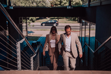 Modern business couple after a long days work, walking together towards the comfort of their home,...