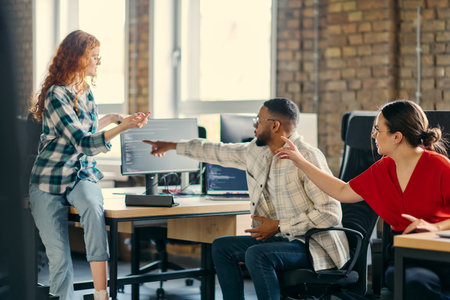 A diverse group of young business individuals congregates in a modern startup coworking center, embodying collaborative innovation and a dynamic atmosphereの写真素材