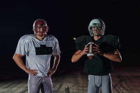 Group of rugby players tightly holding the ball in the dark of night, emanating strength and determination, as they engage in an intense battle showcasing the raw power, skill, and competitive spirit that define the sportの写真素材