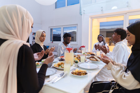 In the sacred month of Ramadan, a diverse Muslim family comes together in spiritual unity, fervently praying to God before breaking their fast, capturing a moment of collective devotion, cultural diversity, and familial joy in the midst of the holy celebrationの写真素材