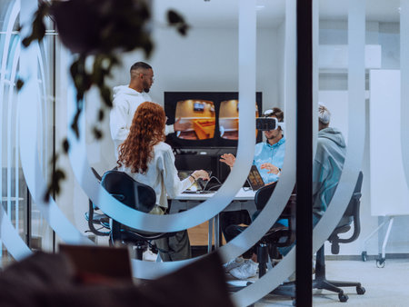 A diverse group of businessmen collaborates and tests a new virtual reality technology, wearing virtual glasses, showcasing innovation and creativity in their futuristic workspaceの写真素材