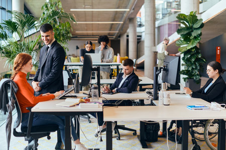 In a modern startup office, a diverse group of young professionals collaboratively tackles various business problems and challenges, surrounded by their engaged colleagues, fostering innovation and productivityの写真素材