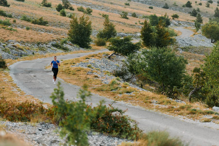 Empowered Runner Embracing Natures Beauty on a Serene Morning Trail.の写真素材