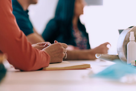 Diverse Business Team Discussing Projects in a Modern Glass Office.
