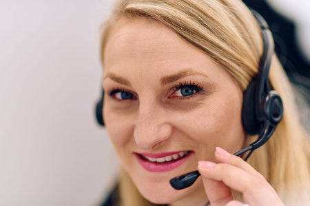 Friendly Call Center Agent Answering Incoming Calls with Headset Providing Remote Customer Service.