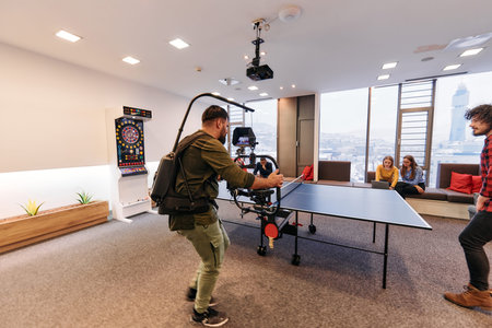 Videographer Captures Business Colleagues Playing Table Tennis During Break