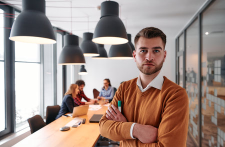 Confident Businessman Leading Collaborative Meeting in Modern Office Setting.の写真素材
