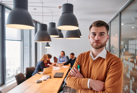 Confident Businessman Leading Collaborative Meeting in Modern Office Setting.の写真素材