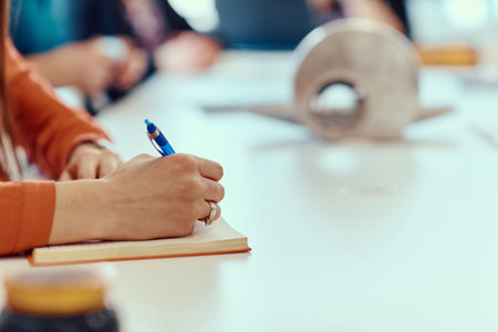 Close-up of Female Hand Holding Pencil Ready for Meeting Notesv