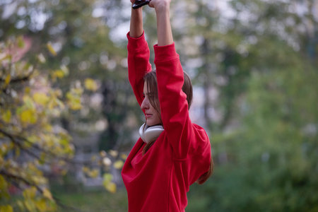 Athletic young woman taking a breath and relaxing after jogging and stretching. Woman Training and...