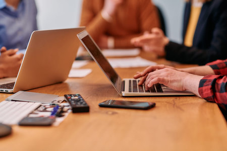 Businessman at work. Close-up top view of man working on laptop while sitting at the wooden desk