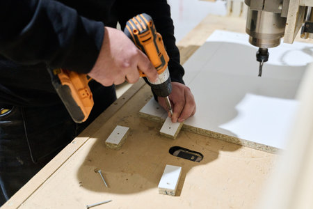 Close-Up of Worker Drilling Wooden Boards to Prepare for Further Processing