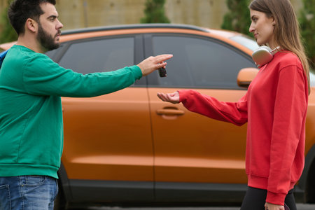Car keys handshake, seller or car salesman and customer in a dealership, shake hands over the car keysの写真素材