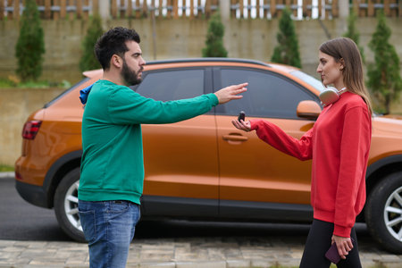 Car keys handshake, seller or car salesman and customer in a dealership, shake hands over the car keysの写真素材